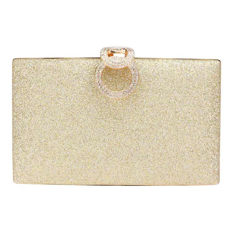 Gold glitter clutch with a decorative ring on a white background