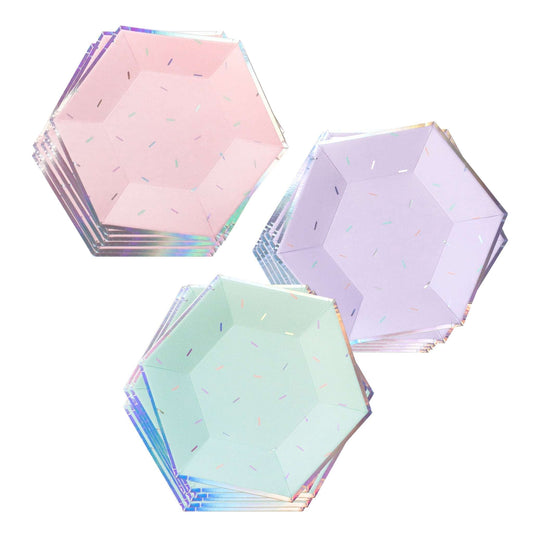 Three stacks of hexagonal paper plates in pastel pink, purple, and green with a sprinkle pattern and iridescent edges.