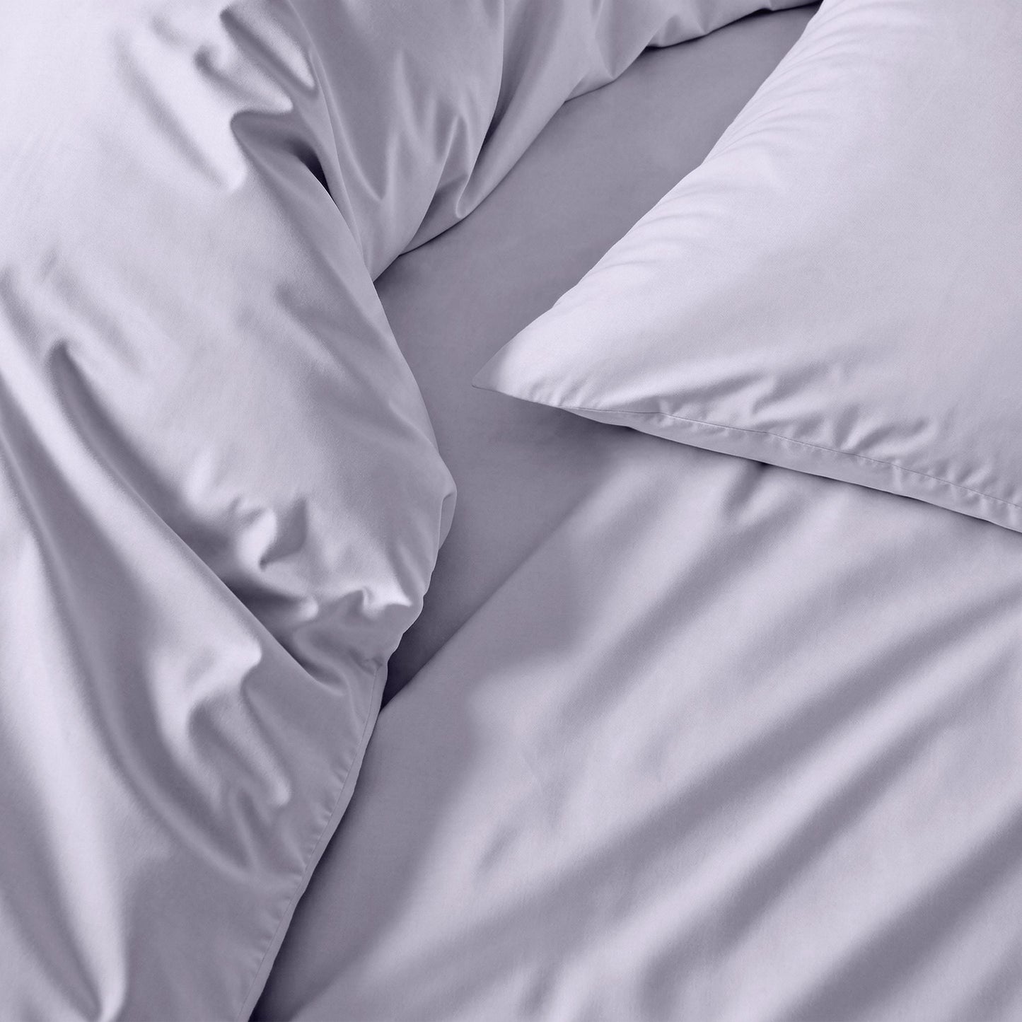 Gray bedding set with pillows on a bed