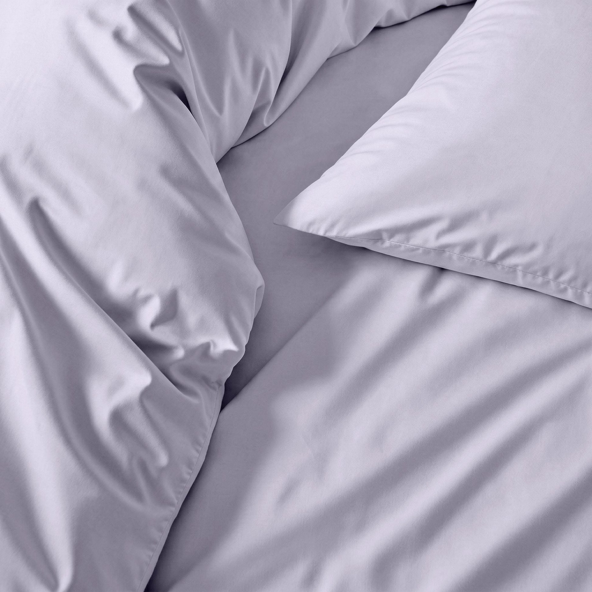 Gray bedding set with pillows on a bed