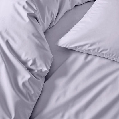 Gray bedding set with pillows on a bed