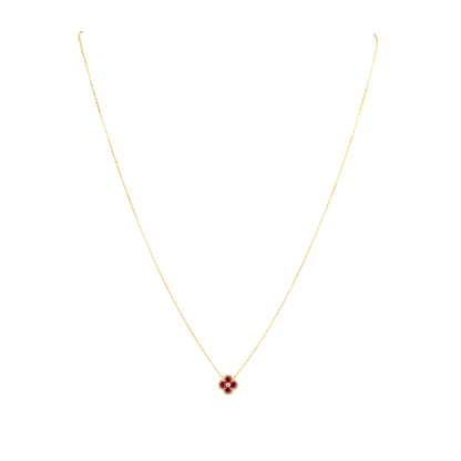 Gold necklace with a red gemstone pendant on a white background