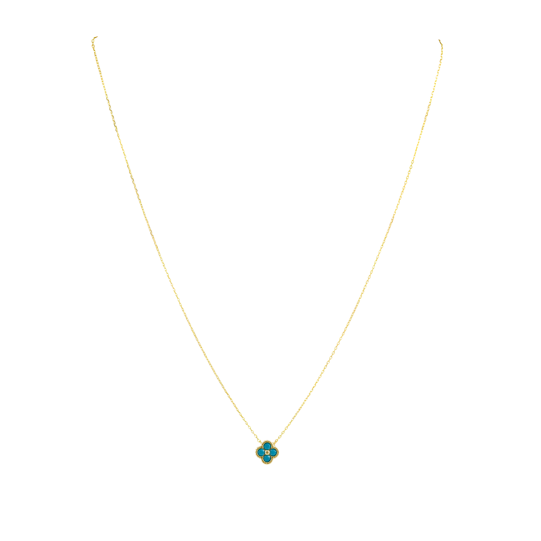 Gold necklace with a green pendant on a white background