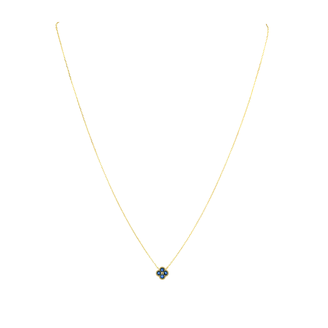 Gold necklace with a blue flower pendant on a white background