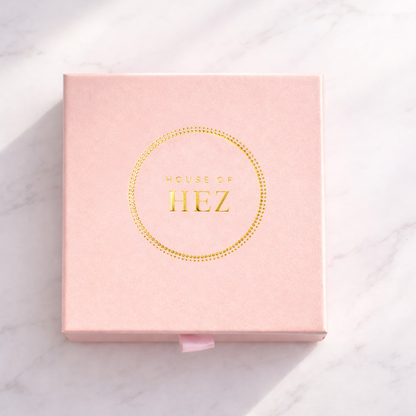 Pink box with 'House of HEZ' branding on a light background