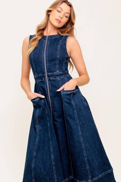 Woman wearing a denim dress against a white background