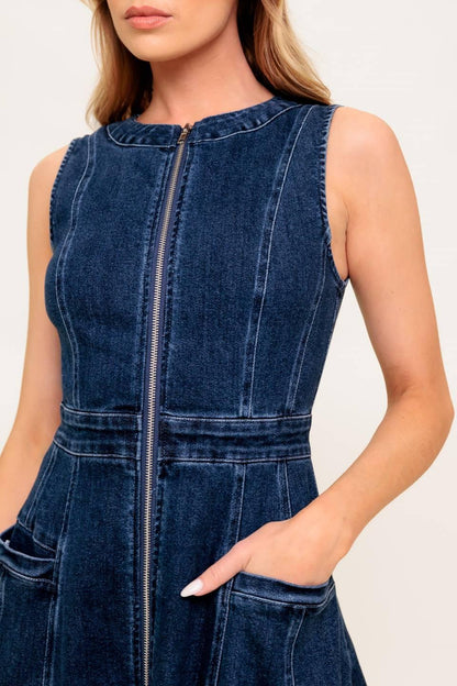 Blue denim dress worn by a person on a white background