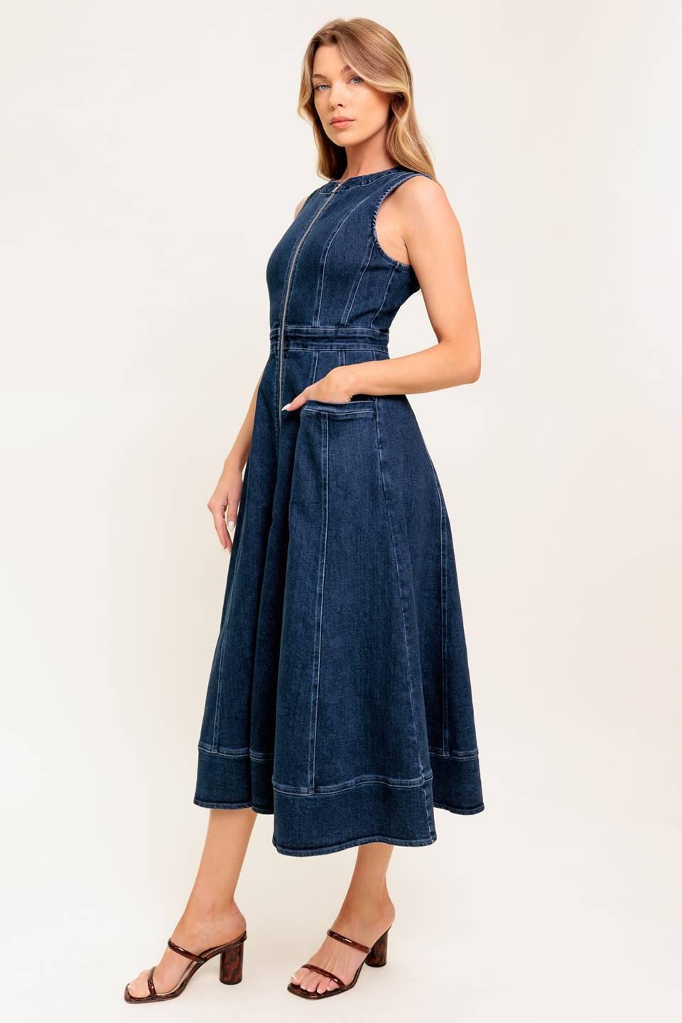 Woman wearing a blue denim dress on a white background