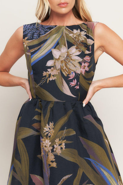 Woman wearing a sleeveless dress with floral pattern on a plain background