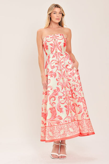 Woman wearing a strapless dress with pink floral pattern on a white background