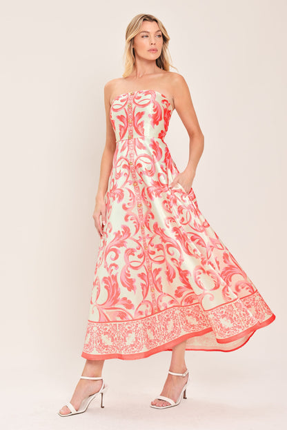 Woman wearing a strapless floral dress with a white background