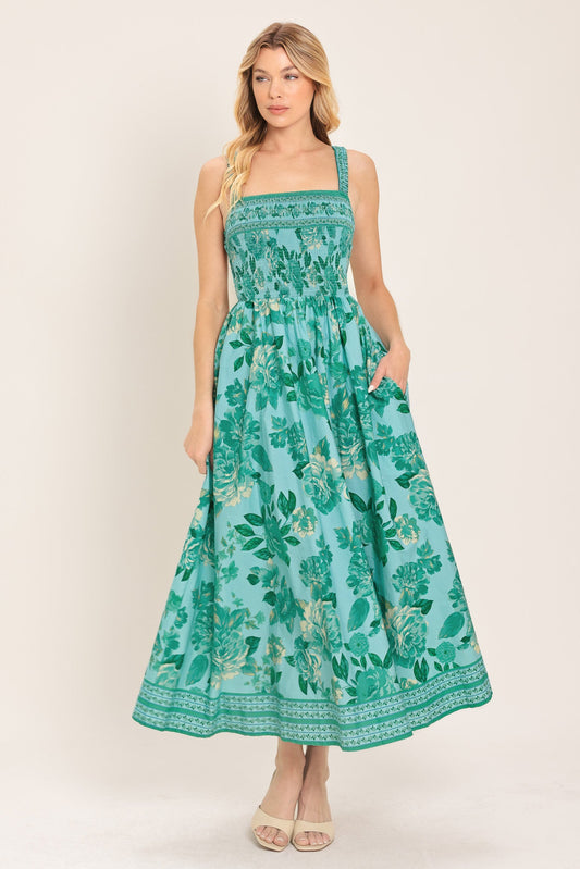 Woman wearing a green floral dress on a white background