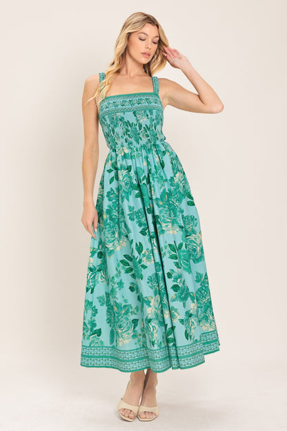 Woman wearing a green floral dress against a white background