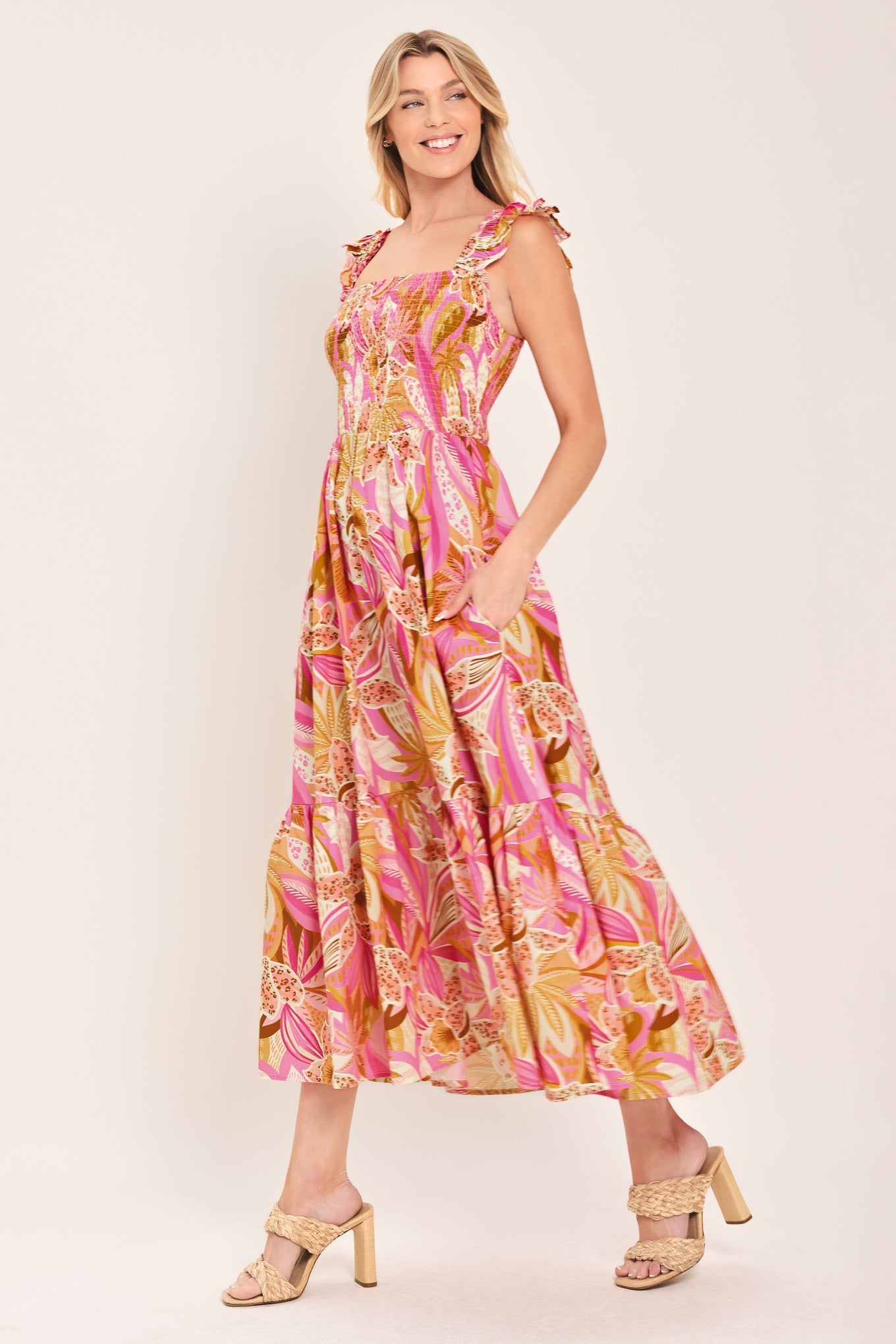 Woman wearing a colorful floral dress on a white background