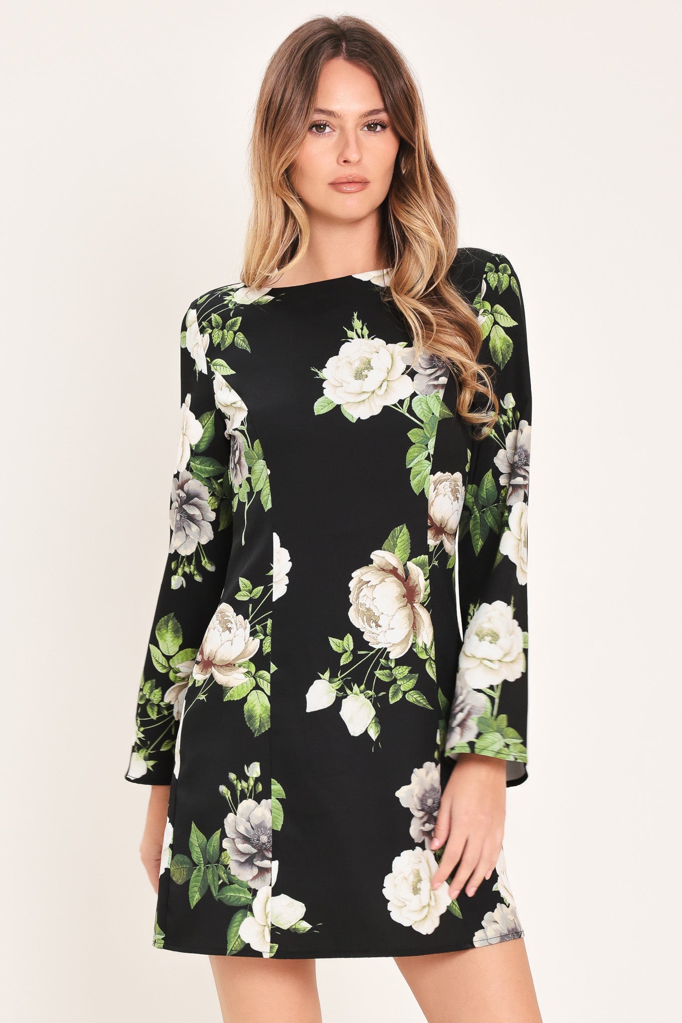Woman wearing a black floral dress on a white background