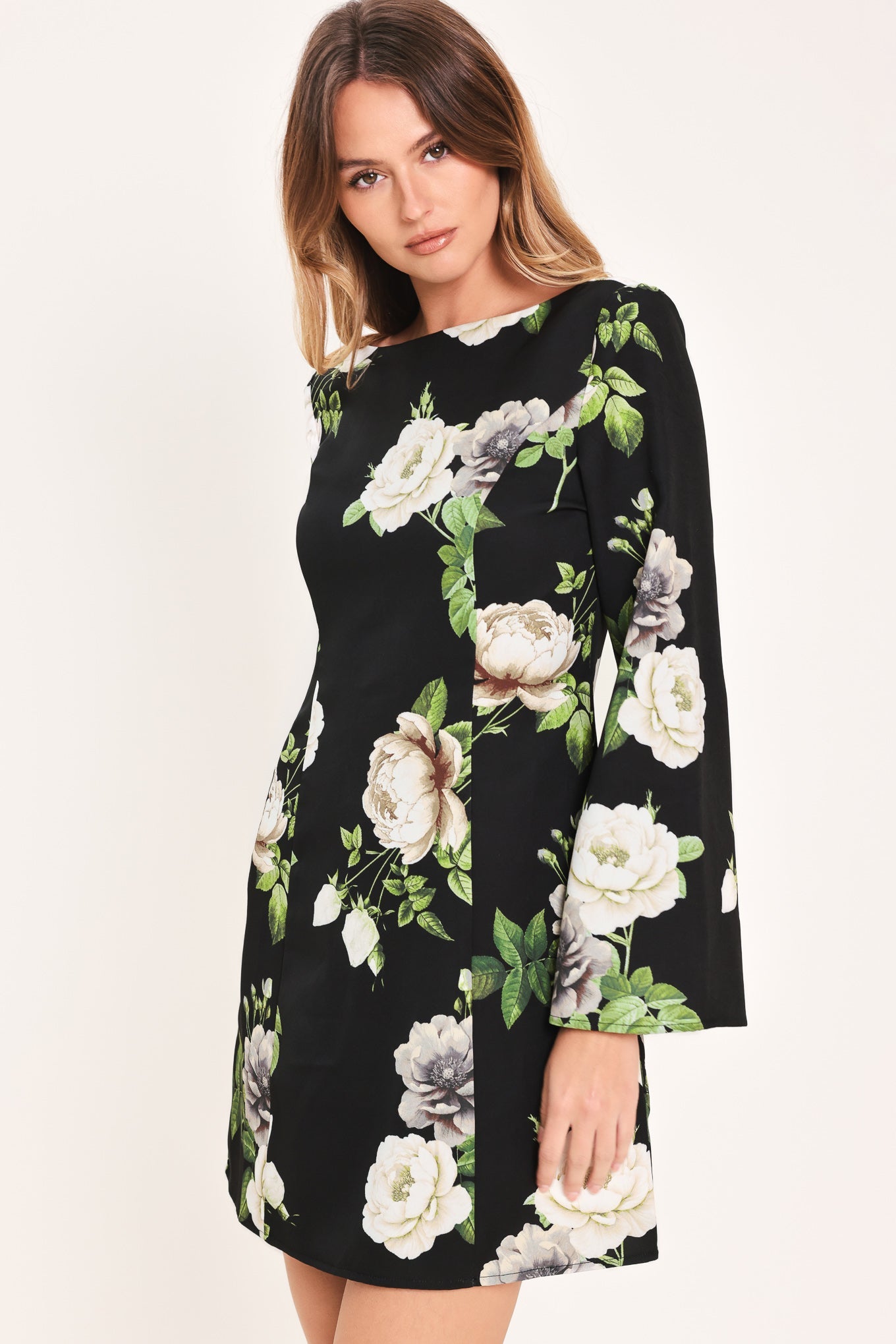Woman wearing a black floral dress on a white background