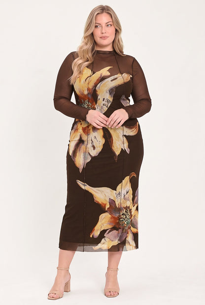 A woman modeling a brown long-sleeve midi dress with sheer mesh sleeves and a large yellow and beige floral print, paired with beige high-heeled sandals against a plain white studio background.