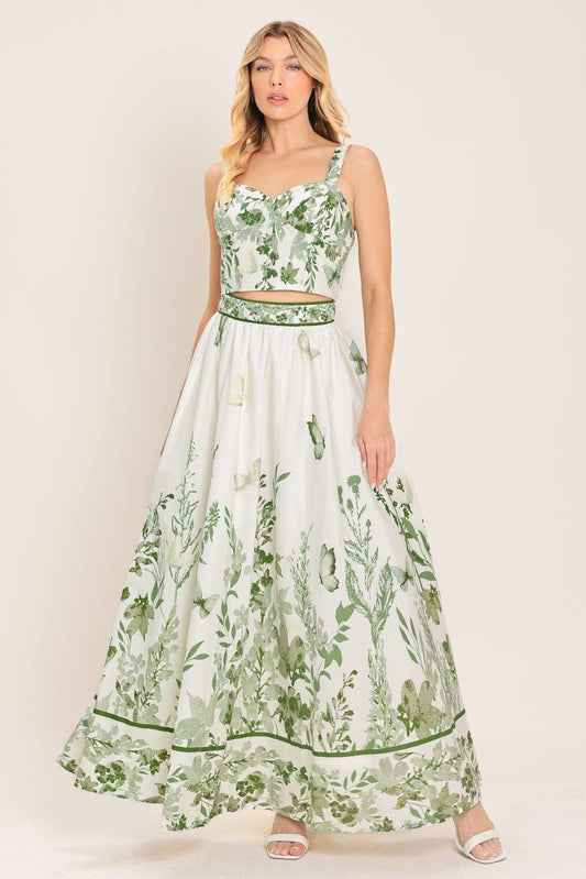 Woman wearing a white floral dress with green details on a beige background