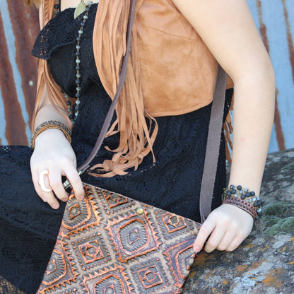 Person holding a patterned bag with a rustic background