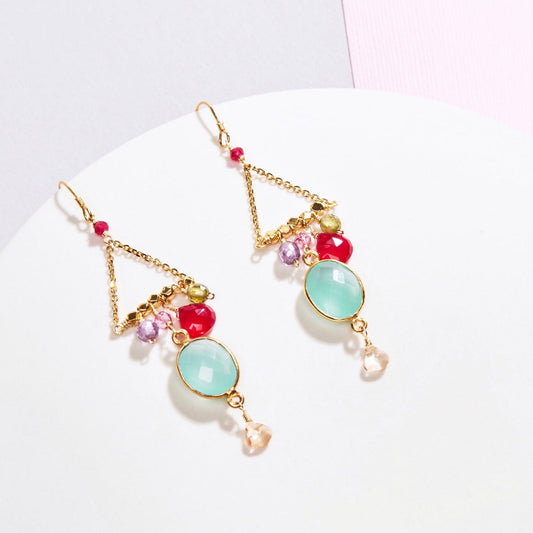 Colorful earrings with gold accents on a white background