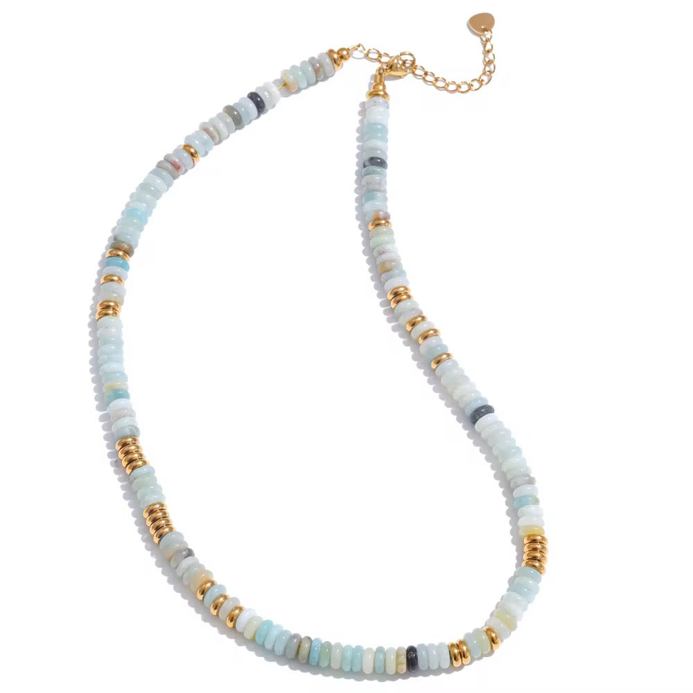 Necklace with multicolored beads and gold accents on a white background