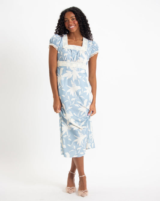 Woman wearing a light blue floral dress.