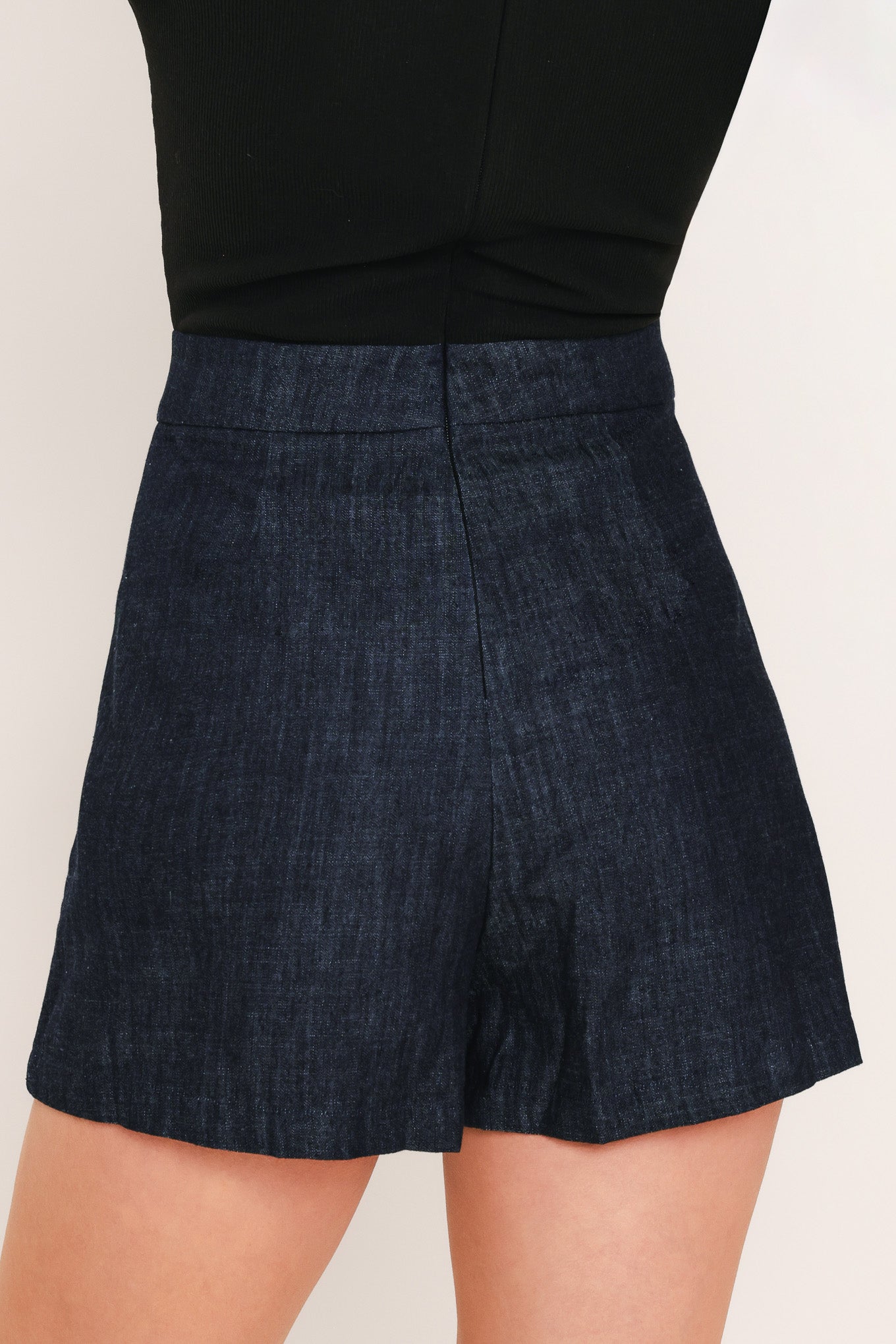Back view of dark wash denim skort
