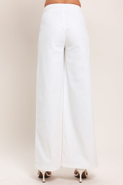 White pants on a beige background