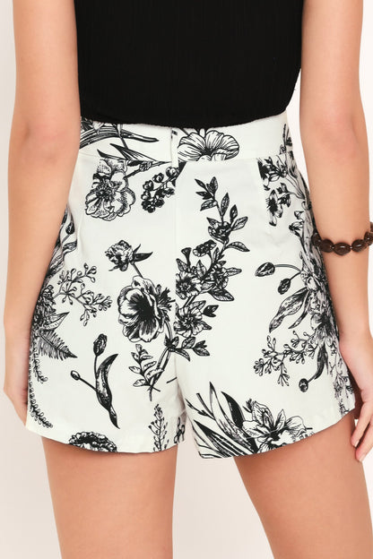 Back view of floral white and black women's shorts.