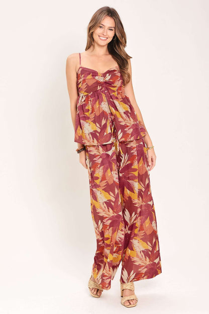 Woman wearing a floral jumpsuit on a white background