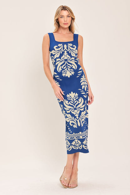 Blue sleeveless midi dress with a white damask jacquard pattern and square neckline.