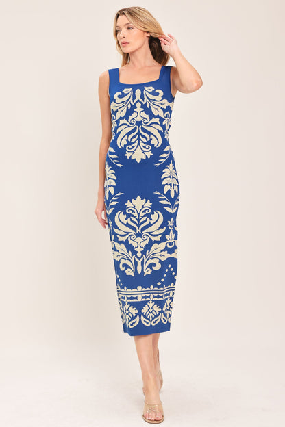 Sleeveless blue midi dress with a cream floral jacquard pattern worn by a model against a white background.