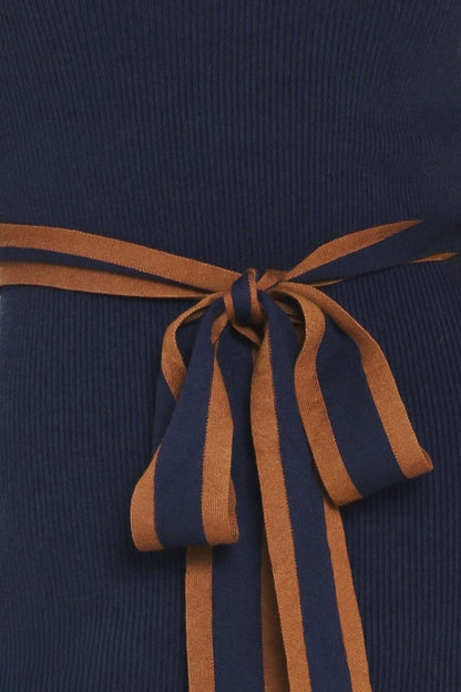 Close-up of a navy blue ribbed fabric with a wide brown tie belt tied in a bow at the center.