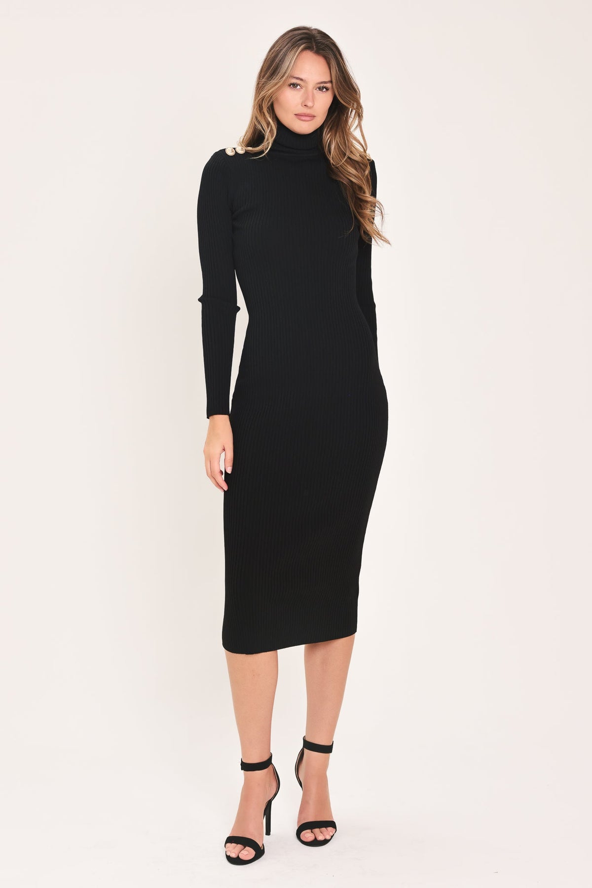 Front view of the black turtleneck sweater midi dress with long sleeves and a fitted silhouette, styled with black heels.
