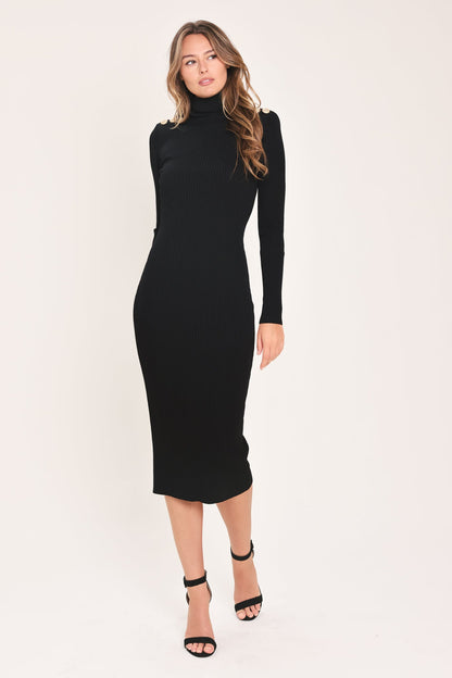  Full-length front view of a model wearing the black long-sleeve sweater midi dress with gold shoulder buttons.