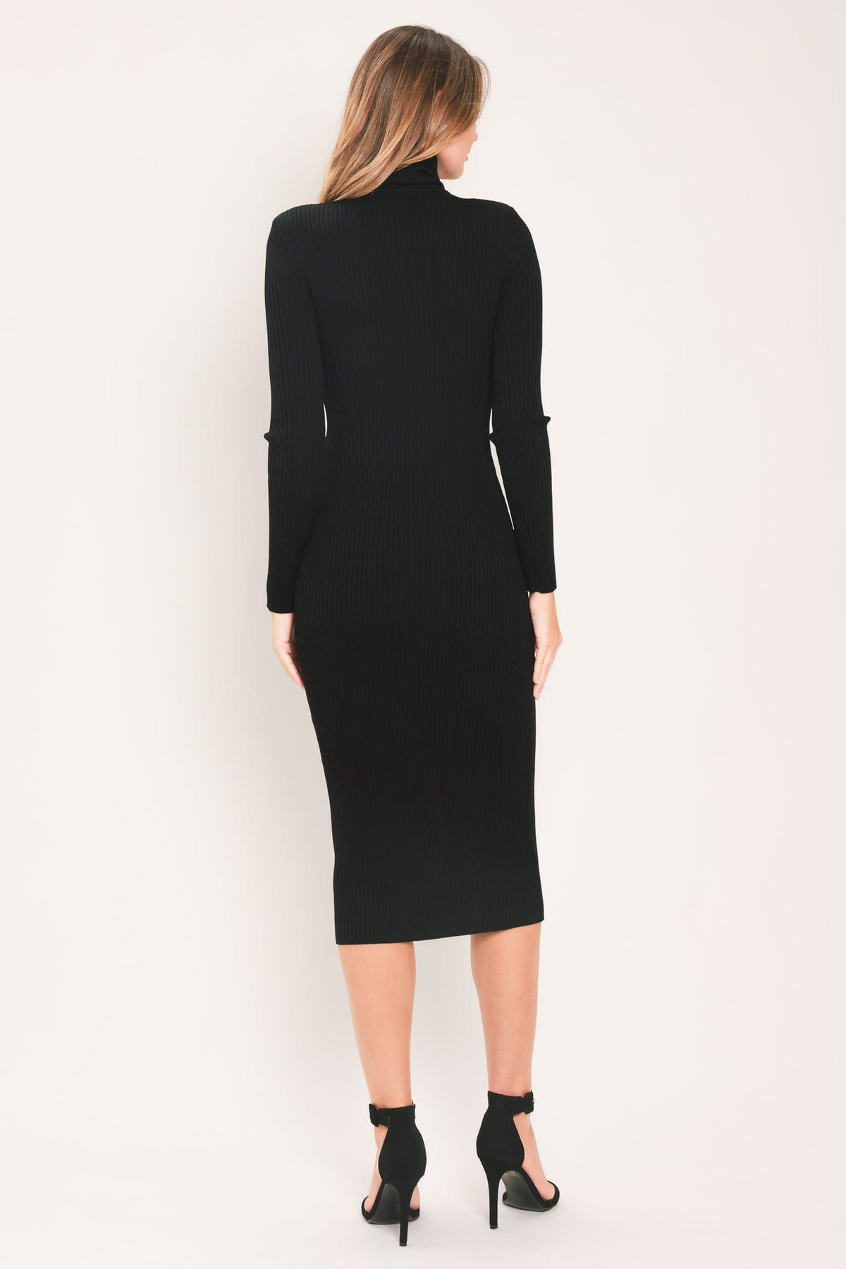 Back view of the fitted black turtleneck sweater midi dress showing long sleeves and a straight midi hem.