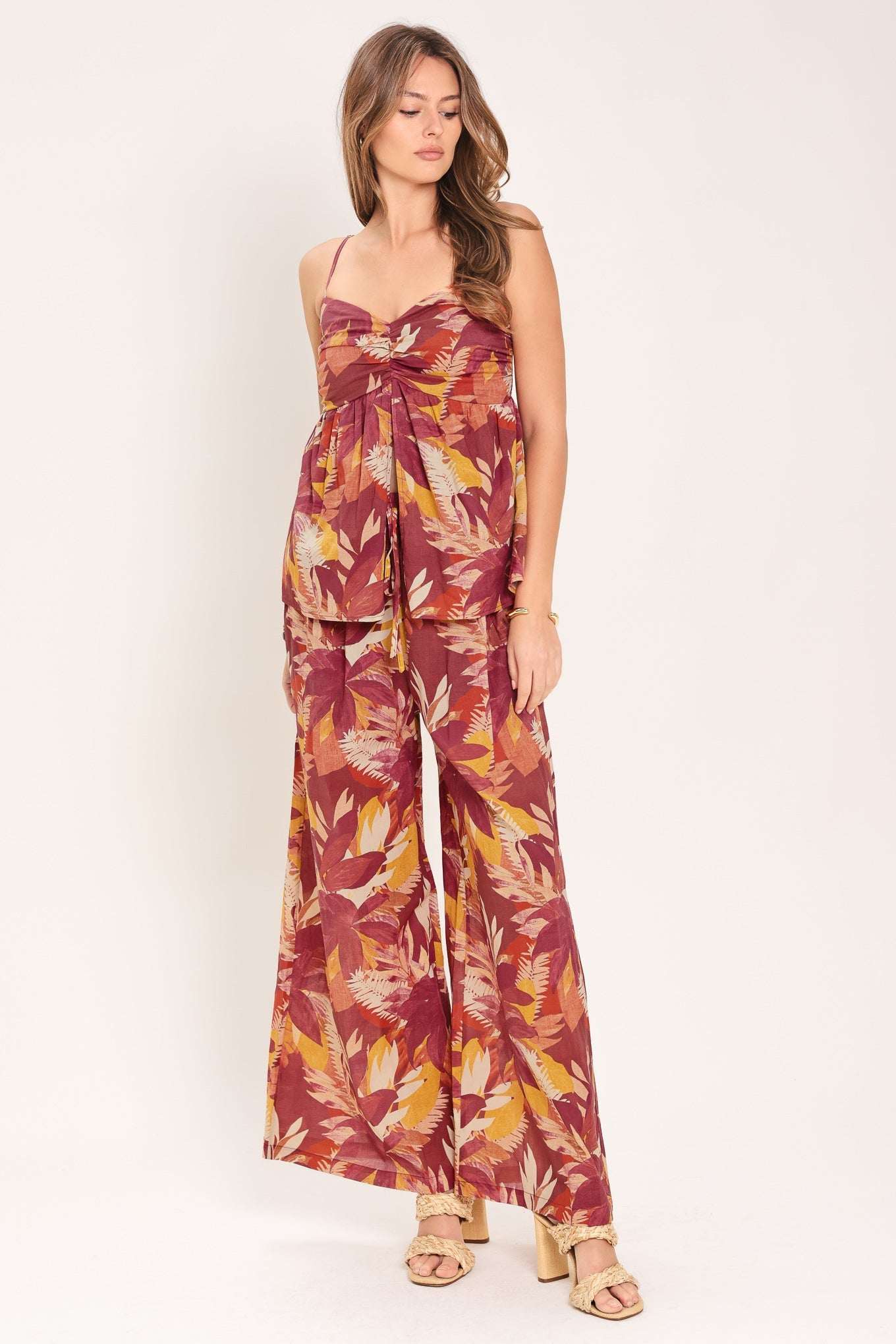 Woman wearing a floral jumpsuit on a white background