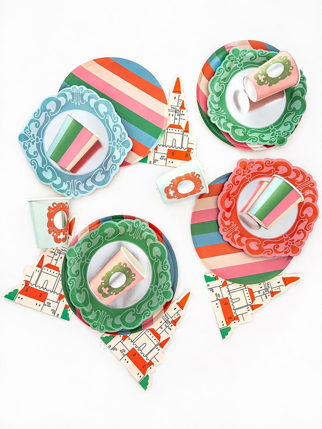 Colorful paper plates, cups, and castle-shaped napkins with ornate frame designs and stripes on a white background.