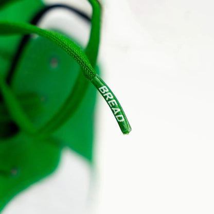 Lucky green elastic shoelaces with "BREAD" printed on the aglet, displayed against a white background.
