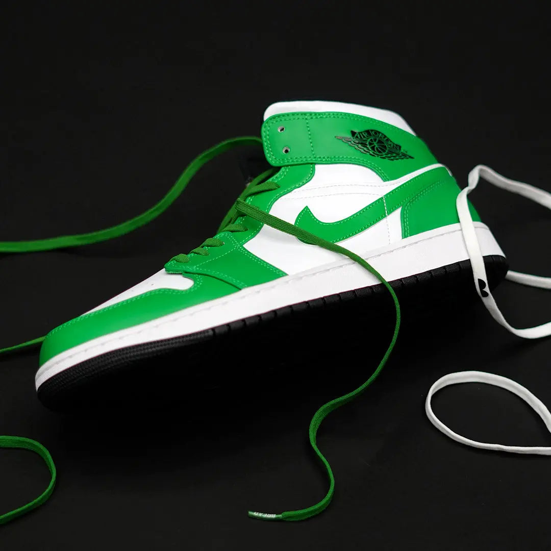 Lucky green elastic shoelaces displayed alongside a green and white sneaker on a black background.