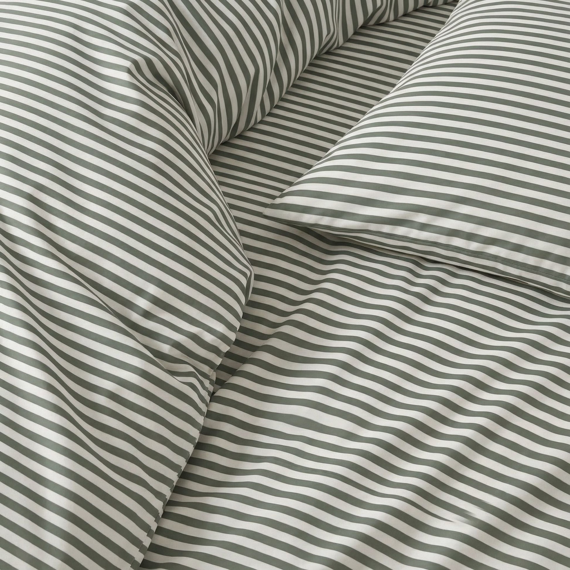 Close-up of striped fabric with green and white stripes.