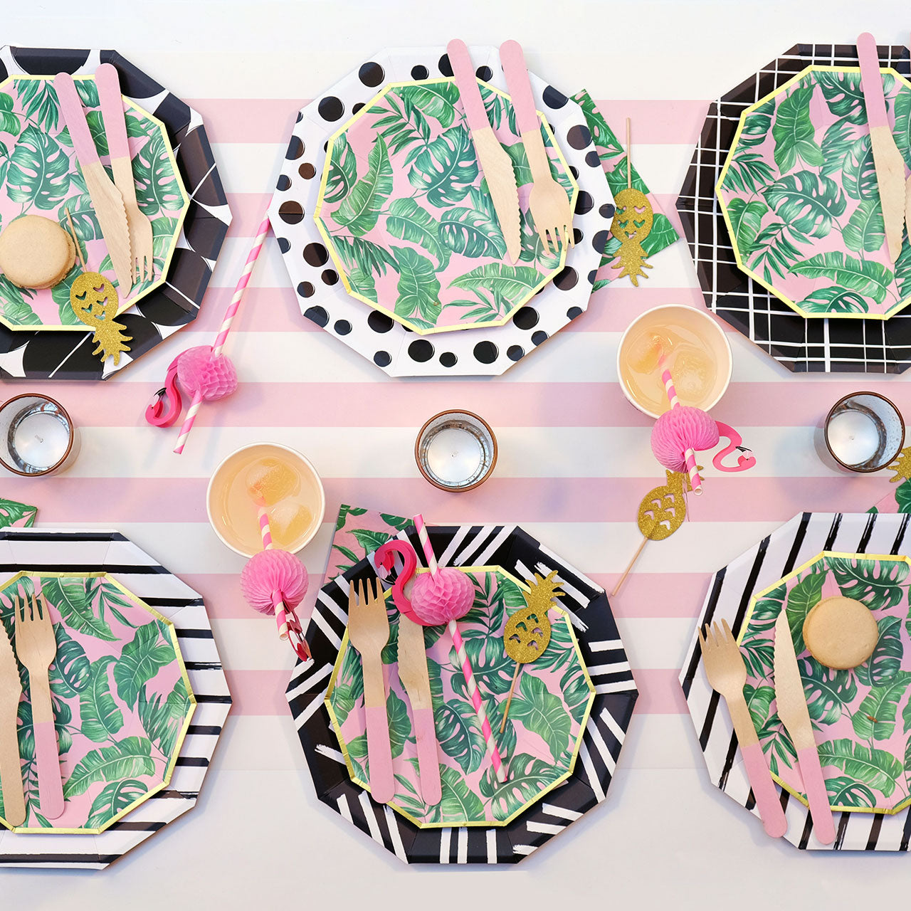 Tropical theme party table setting featuring pink flamingo paper drinking straws.