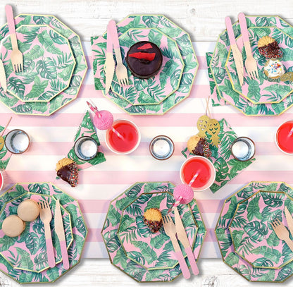 Tropical theme party table setting featuring pink flamingo paper drinking straws.
