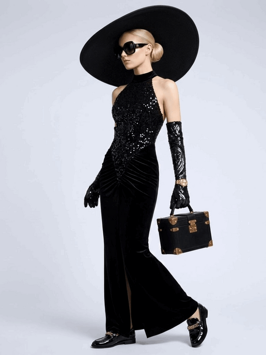 Model wearing the Madison black halter gown with a sequined bodice, draped hips, and floor-length mermaid skirt.