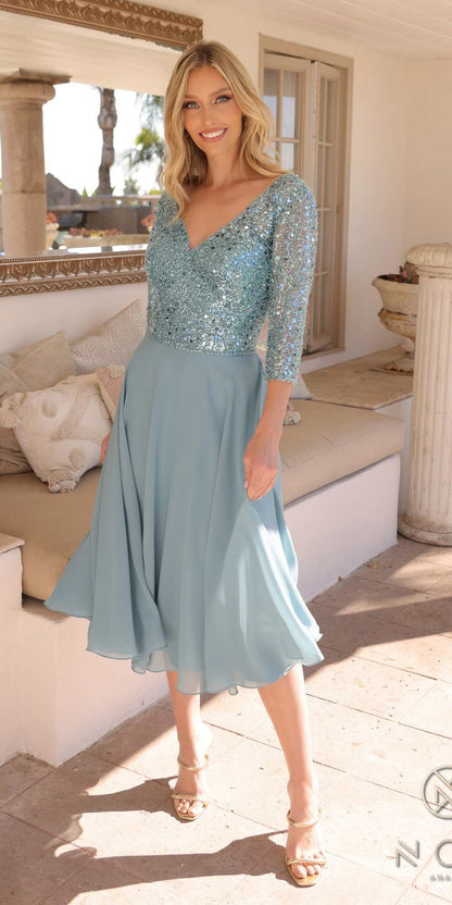 Woman wearing a light blue dress with sequin top in an outdoor setting