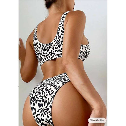 Split swimsuit featuring a leopard print design with contrasting colors, shown from the back on a model.