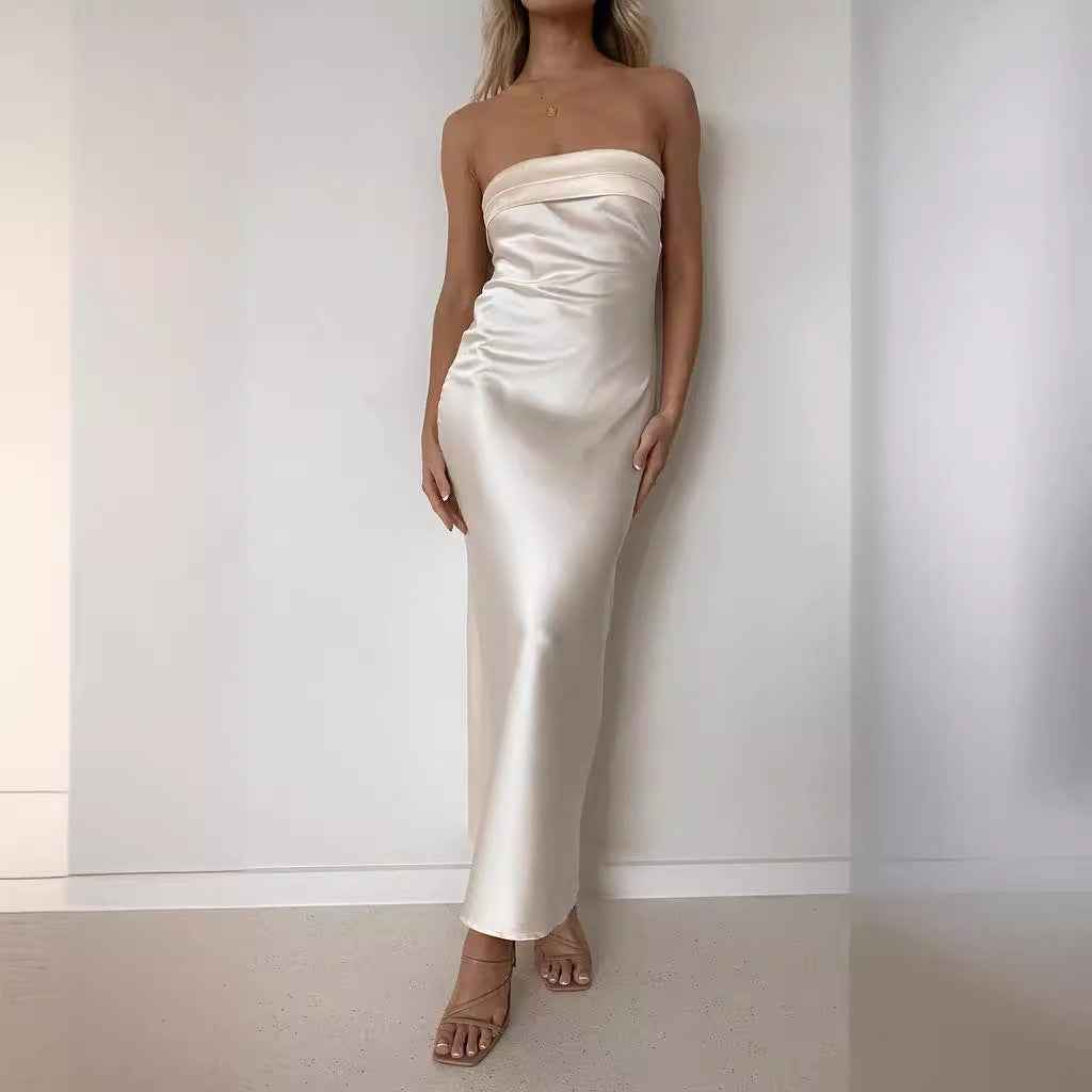 Satin strapless backless midi dress in cream, featuring a side slit and fitted silhouette, worn by a model.