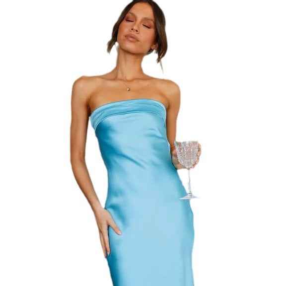 Satin strapless backless midi dress in light blue with a thigh-high slit, model holding a glass.