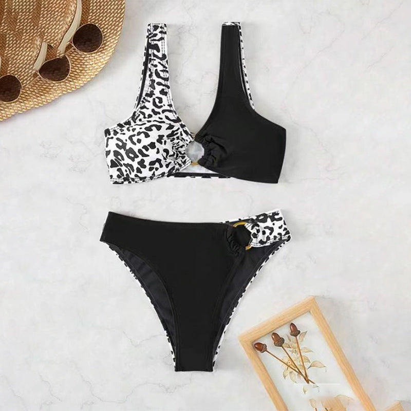 Split swimsuit featuring leopard print and contrasting black color, with a unique design and high-waisted bottom.