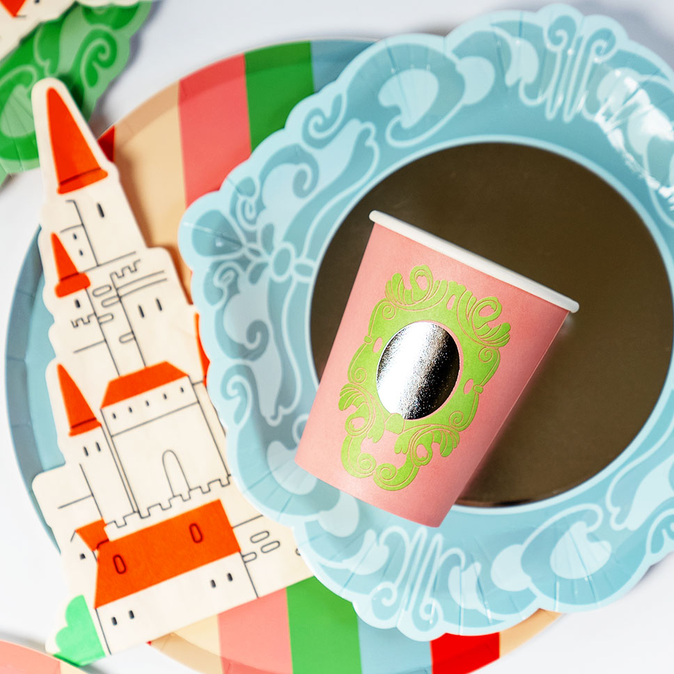 Pink paper cup, blue scalloped plate, and castle-shaped napkin from the Pop Party Princess Party Pack.
